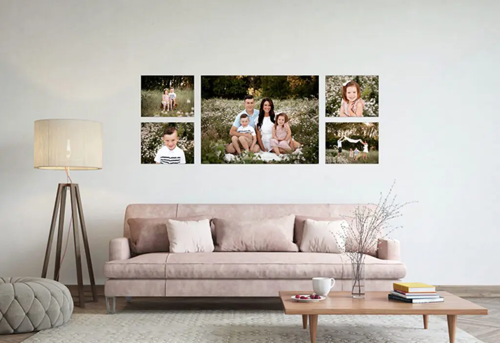 Framed family wall art displayed above a pink couch in a living room. The images portray a happy family in a flower field at sunset snuggled together and playing. Perfect for families in Cedar Falls, Iowa, and surrounding areas like Waterloo, Waverly, and Hudson.