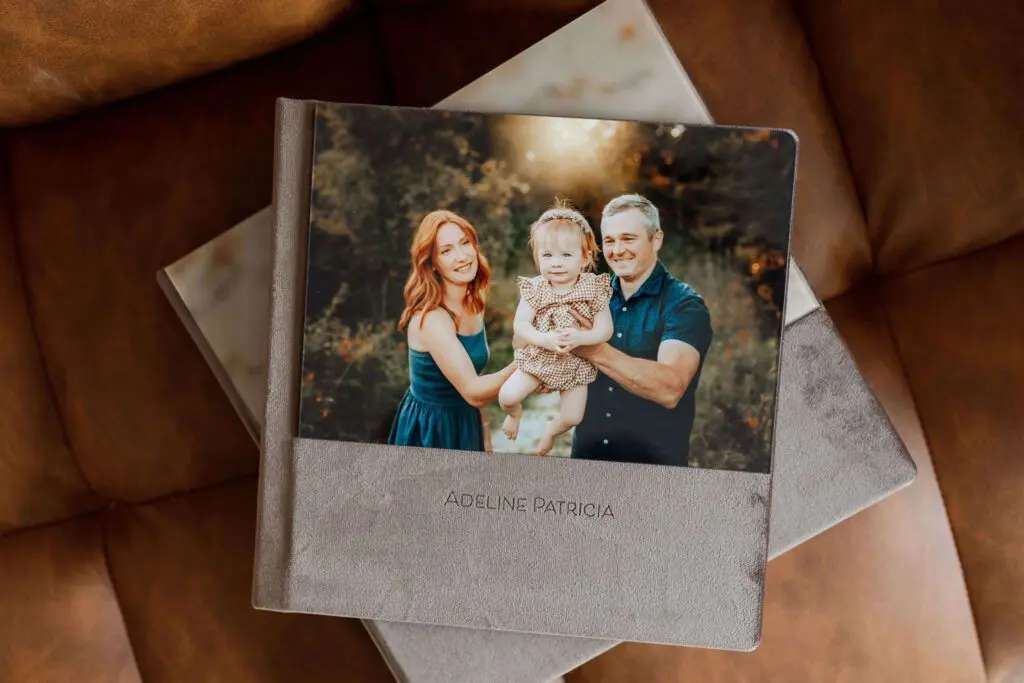 Custom family photo album with a suede cover, featuring a family portrait, available in Cedar Falls, Iowa. Serving families in Cedar Falls, Evansdale, Janesville, and Dike.