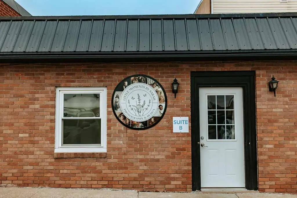 Exterior of a newly purchased photography studio in Cedar Falls, Iowa, featuring the 'Little Moments by Sarah' sign. Conveniently located for clients in Waterloo, Evansdale, Grundy Center, and other nearby cities seeking professional photography services.