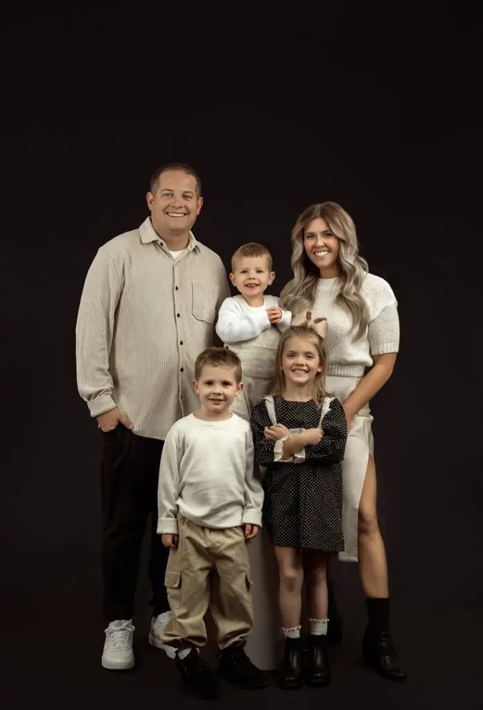 Elegant family portrait captured at indoor photography studio near Waterloo, Iowa.