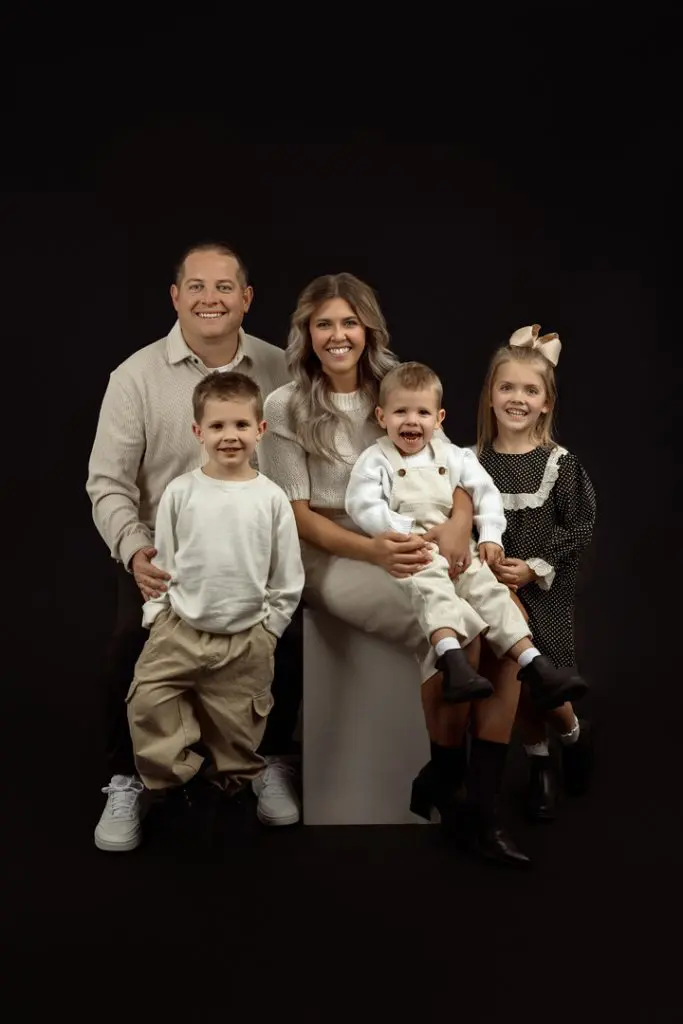 Family smiling together during their indoor studio photography session near Waverly, IA.
