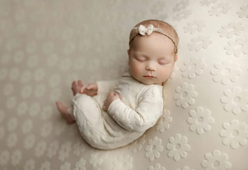 Classic newborn portrait with neutral tones from iconic newborn session in Cedar Falls, Iowa.