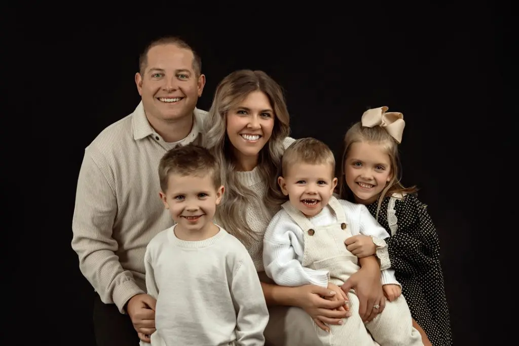 Close-up family portrait in minimalist glam style capturing genuine smiles in Cedar Falls, IA.