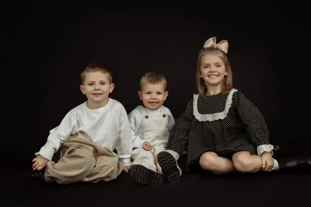 Playful sibling photo taken at family photography studio near Evansdale, Iowa.