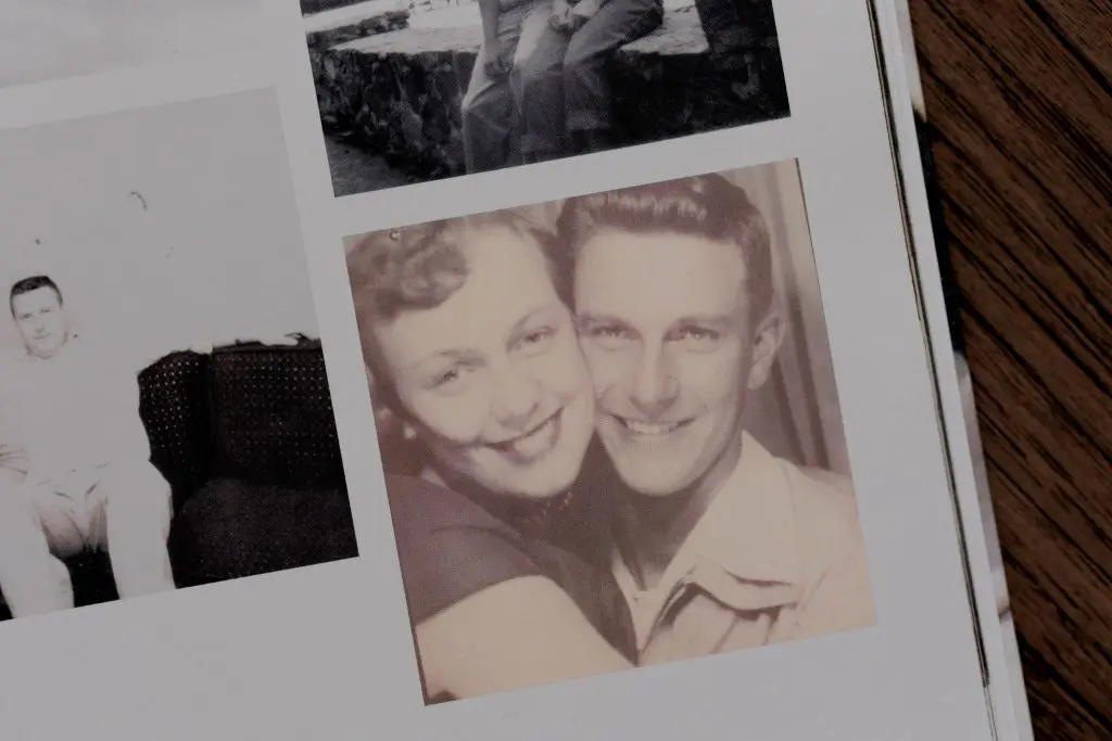Vintage photo booth-style image of a young couple smiling and embracing.