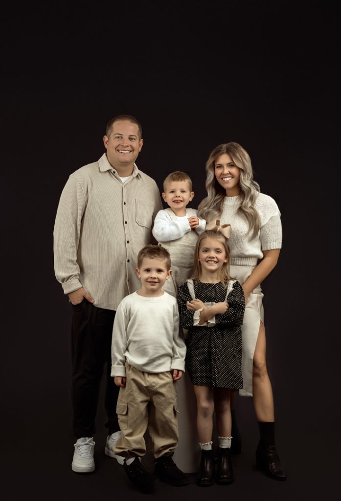 Elegant family portrait captured at indoor photography studio near Waterloo, Iowa.