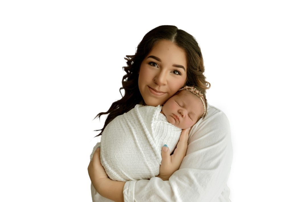Mother holding newborn baby girl lovingly in Cedar Falls photography studio.