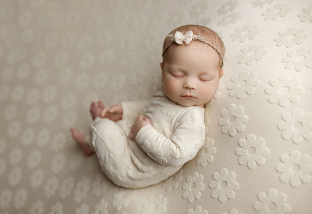 Classic newborn portrait with neutral tones from iconic newborn session in Cedar Falls, Iowa.