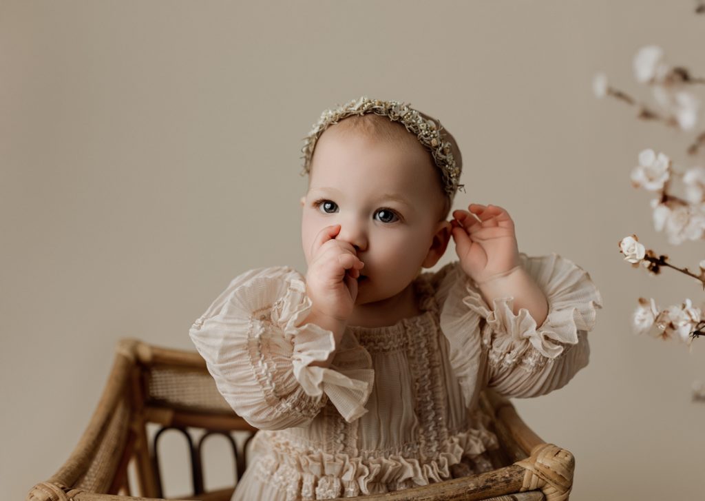 Sweet baby sucking thumb during natural portrait session near Cedar Valley.