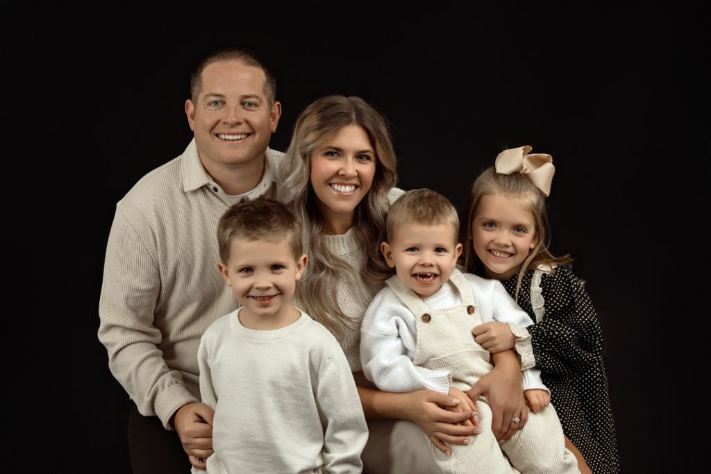 Close-up family portrait in minimalist glam style capturing genuine smiles in Cedar Falls, IA.
