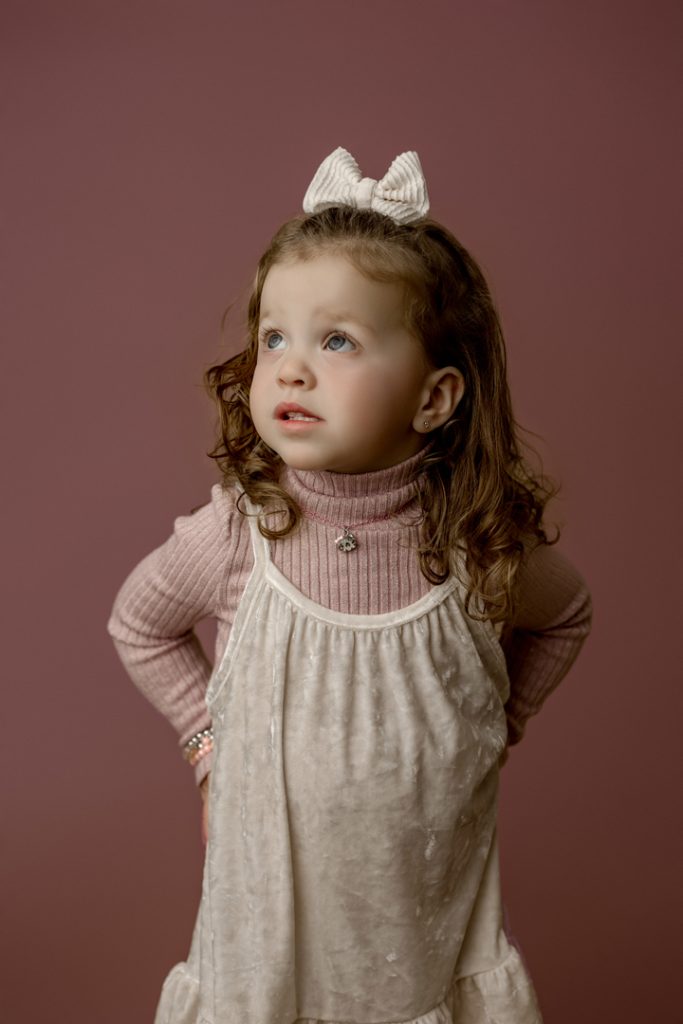 Mabel looking up with a sweet expression during her mini session in Cedar Falls, Iowa.