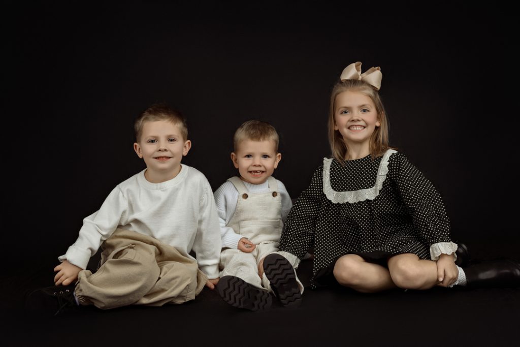 Playful sibling photo taken at family photography studio near Evansdale, Iowa.