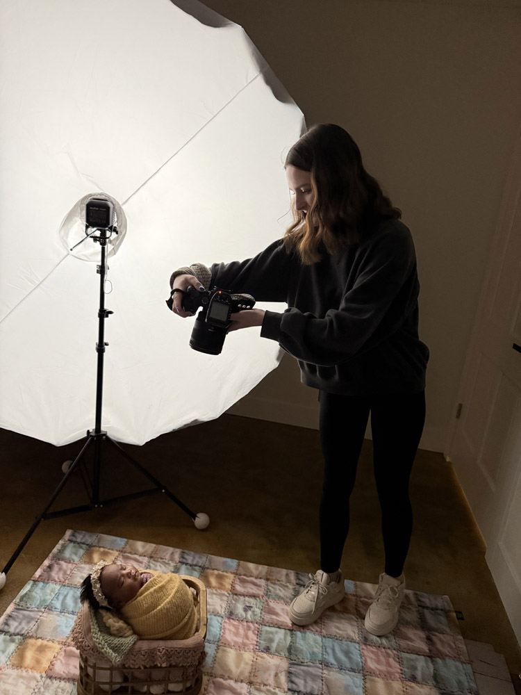 High school intern Kaylen behind the scenes photo learning photography skills in Cedar Falls studio.