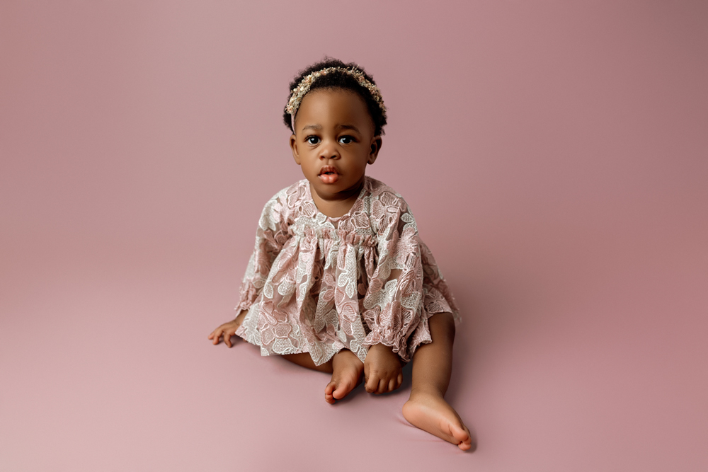 Studio portrait of 12 month old baby girl Amy during milestone session in Cedar Falls Iowa