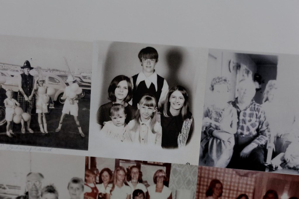 Vintage black and white portrait of siblings grouped together for a family photo.
