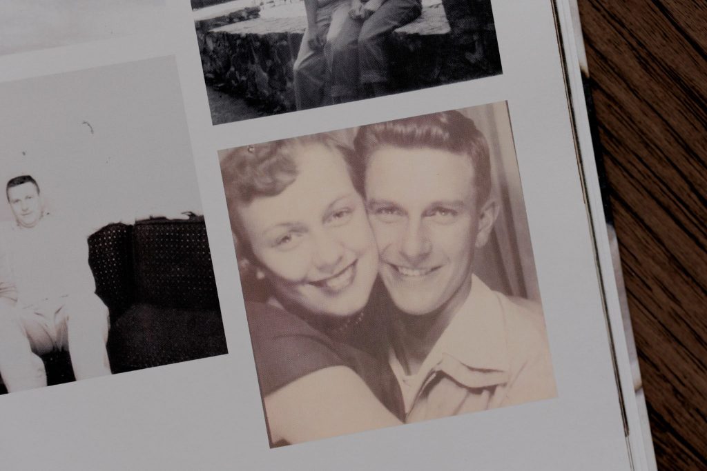 Vintage photo booth-style image of a young couple smiling and embracing.